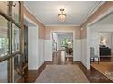 Inviting foyer with hardwood floors, detailed trim, and a view to other rooms at 2011 Fromby Ct, Charlotte, NC 28211