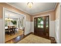 Inviting foyer with detailed trim, hardwood floors and view to the formal dining at 2011 Fromby Ct, Charlotte, NC 28211