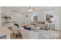 Bright living room with two armchairs, statement throw pillows, and windows that let in natural light at 207 Putnam St, Shelby, NC 28152
