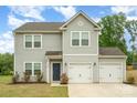 Two-story home featuring gray siding, an attached two-car garage, and a well-maintained front lawn at 2507 Waverly Dr, Monroe, NC 28112