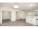 Spacious area featuring neutral walls, modern floors, and a view of the stairs and partial kitchen view at 2507 Waverly Dr, Monroe, NC 28112