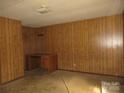 Bedroom with wood paneling and a desk against the wall at 2927 S Nc 16 Hwy, Newton, NC 28658