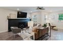 Inviting living room with black brick fireplace, ceiling fan, and large windows that provide natural light at 3307 Draper Ave, Charlotte, NC 28205