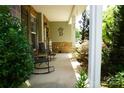 Cozy covered porch with rocking chairs, stone accents, and a welcoming entrance at 4003 Northerly Island Ct, Gastonia, NC 28056