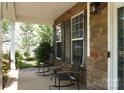 Inviting front porch with stone accents, rocking chairs and pleasant view at 4003 Northerly Island Ct, Gastonia, NC 28056