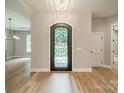 Grand foyer featuring an ornate black metal door, light hardwood floors, and neutral walls at 4028 Spindrift Cove Dr # 59 And 60, Denver, NC 28037
