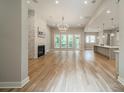 Expansive living room boasts a stone fireplace, hardwood floors, and plenty of natural light at 4028 Spindrift Cove Dr # 59 And 60, Denver, NC 28037