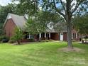 Traditional brick home with a well-manicured lawn and inviting front porch at 4402 Poxon Ln, Monroe, NC 28110