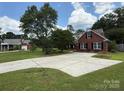 Classic brick home with a wide driveway and beautiful landscaping at 4402 Poxon Ln, Monroe, NC 28110