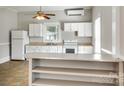 Well-lit kitchen features white cabinets, an oven, and a breakfast bar for easy entertaining at 514 Jones St, Chester, SC 29706