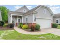 Landscaped front yard with gray siding, a brick foundation, and a well-kept lawn at 5141 Grandview Dr, Fort Mill, SC 29707