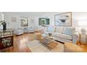 Bright living room with hardwood floors, modern furnishings, and large windows, creating a welcoming atmosphere at 5211 Londonderry Rd, Charlotte, NC 28210