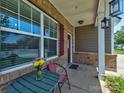 Charming front porch seating area perfect for enjoying a morning coffee or reading a book at 5797 Mcclintock Dr, Denver, NC 28037