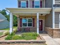 Inviting front porch with charming decor, providing a cozy outdoor seating area at 5797 Mcclintock Dr, Denver, NC 28037