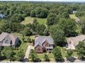 Aerial view of a home with mature trees, showcasing landscaping and neighborhood at 6523 Alba Rose Ln, Huntersville, NC 28078