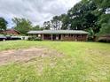 Traditional brick home with covered front porch, spacious lawn, and driveway area for convenient parking at 6539 Louglen Cir, Charlotte, NC 28212