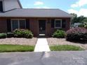 Charming brick home featuring a well-manicured front yard and inviting entryway at 833 21St Ne Ave # 833, Hickory, NC 28301