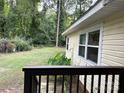 Side view from deck showing home's siding and spacious backyard with lush greenery at 1010 Sprucewood St, Kannapolis, NC 28081