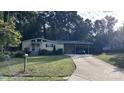 Street view of home, showing the carport, driveway, and manicured front lawn at 1010 Sprucewood St, Kannapolis, NC 28081