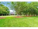 Lovely home with a large front yard featuring mature trees and a well-maintained lawn at 1042 Heather Glen Dr, Matthews, NC 28104