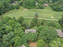 Aerial view of property backing onto a golf course, surrounded by lush trees and landscaping at 106 Boyter Ct, Cramerton, NC 28032