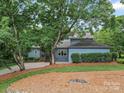 Charming home with mature trees, attractive landscaping, and a well-maintained lawn at 106 Boyter Ct, Cramerton, NC 28032