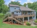 Expansive deck with multiple seating areas and a fire pit, perfect for outdoor entertaining at 106 Boyter Ct, Cramerton, NC 28032