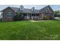 Inviting brick home with a covered front porch and green lawn, showcasing classic curb appeal at 110 Kimberly Ln, Kings Mountain, NC 28086