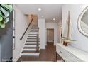 Bright foyer with staircase and hardwood floors, complemented by stylish decor and an open entryway leading to other rooms at 122 Wesser St # 14, Davidson, NC 28036