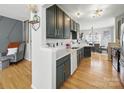 Bright kitchen featuring stainless steel appliances, dark cabinets, and hardwood flooring at 12320 Verdant Ct, Charlotte, NC 28273