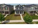 Aerial view of two-story home with stone facade, landscaping, and sidewalk at 125 Cedar Knoll Cir, Pineville, NC 28134