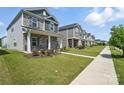A row of modern homes with well-kept lawns and inviting curb appeal on a sunny day at 125 Cedar Knoll Cir, Pineville, NC 28134