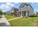 A neighborhood street featuring well-manicured lawns and attractive two-story homes on a sunny day at 125 Cedar Knoll Cir, Pineville, NC 28134
