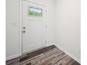 Bright entryway featuring a white door with a window and stylish laminate flooring at 125 Fosters Glen Pl, Mooresville, NC 28115