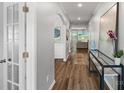 Hallway featuring hardwood floors, decorative art, and an open view to the living room at 131 Cherry Bark Dr, Mooresville, NC 28117