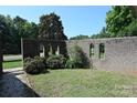 Brick courtyard featuring arched openings and lush green landscaping at 157 Blackberry Ln, Taylorsville, NC 28681