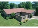 Charming brick home featuring an attached two-car garage and unique brick courtyard walls and a spacious lawn at 157 Blackberry Ln, Taylorsville, NC 28681