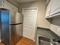 Galley kitchen featuring stainless steel refrigerator and convenient pantry storage at 1600 Sharon W Rd # 16, Charlotte, NC 28210
