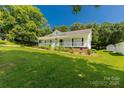 Attractive one-story home with a welcoming porch, tidy landscaping, and lush green lawn at 1675 Old Lynwood Cir, Lancaster, SC 29720