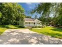 Inviting one-story home framed by mature trees, featuring a cozy porch and a spacious front yard at 1675 Old Lynwood Cir, Lancaster, SC 29720