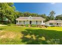Attractive one-story home with a welcoming porch, tidy landscaping, and lush green lawn at 1675 Old Lynwood Cir, Lancaster, SC 29720