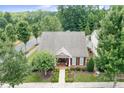 An aerial view showcases a beautiful single-story home with lush landscaping and a well-maintained neighborhood at 18236 Coulter Pkwy, Cornelius, NC 28031
