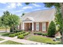 A beautiful stone-accented home with a manicured lawn, shrubs, and well-placed tree in a desirable neighborhood at 18236 Coulter Pkwy, Cornelius, NC 28031