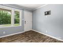 Clean entryway with a window view, a white door, and wood-look flooring; minimalist and bright at 2476 Cane Mill Rd, Lancaster, SC 29720