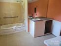 Outdated bathroom features a combination tub/shower and single sink vanity in need of remodel at 275 Hiddenite Church Rd, Hiddenite, NC 28636