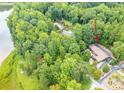 Aerial view of home on a large wooded lot with lake access and lengthy driveway at 2915 Old Stage Rd, Gastonia, NC 28052
