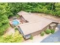 An aerial shot of the home highlighting the backyard pool, screened porch and surrounding lush greenery at 2915 Old Stage Rd, Gastonia, NC 28052