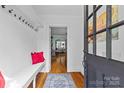 Bright foyer with hardwood floors, coat hooks and a view into the home at 3035 Florida Ave, Charlotte, NC 28205