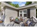 Cozy front porch with seating area, decorative pillows, and brick accents at 3035 Florida Ave, Charlotte, NC 28205