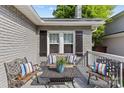 Comfortable covered front porch with seating, ideal for relaxing and unwinding outside the home at 3035 Florida Ave, Charlotte, NC 28205